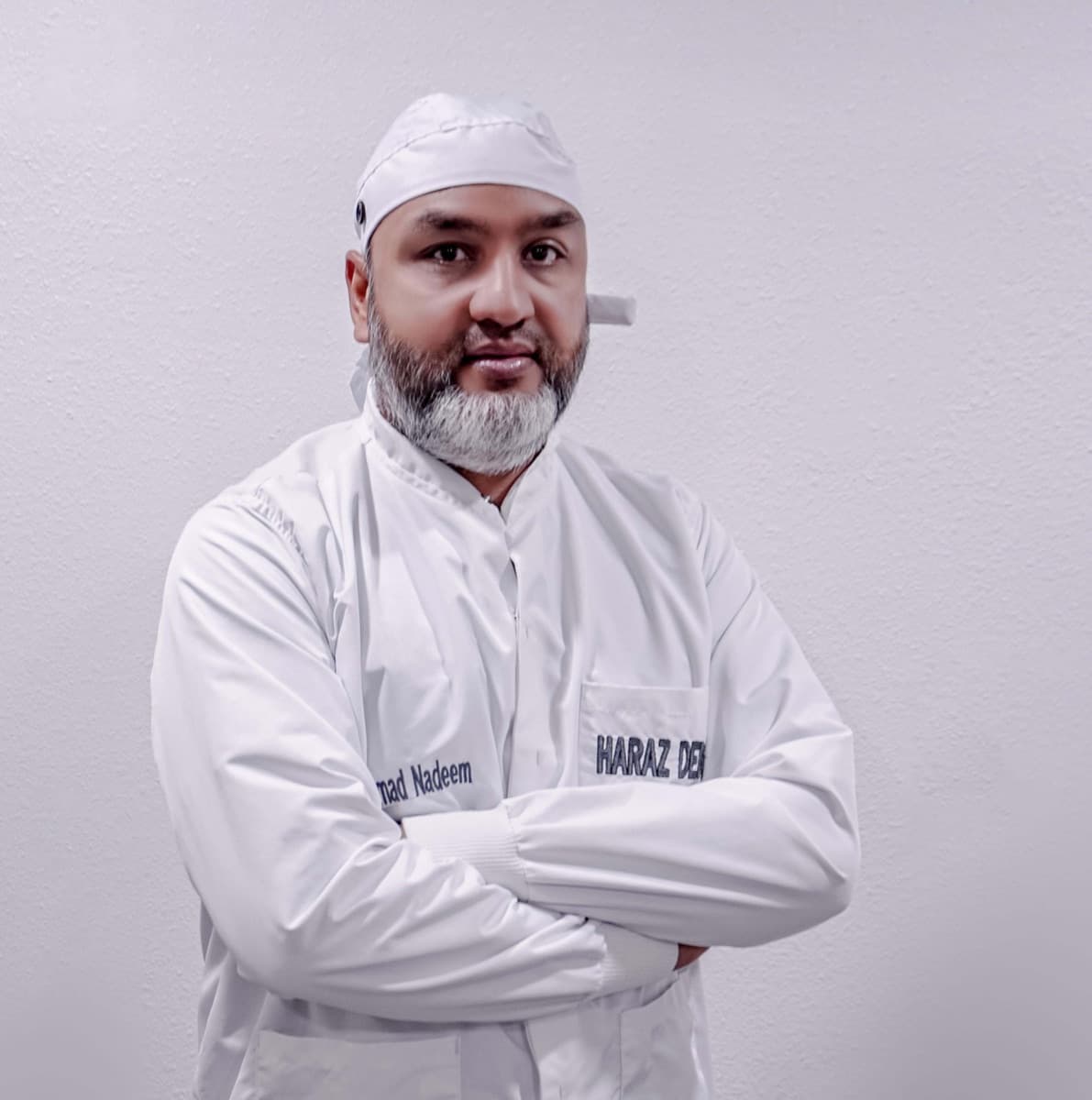 Dr. Nadeem of Haraz Dental Group in a white clinic coat