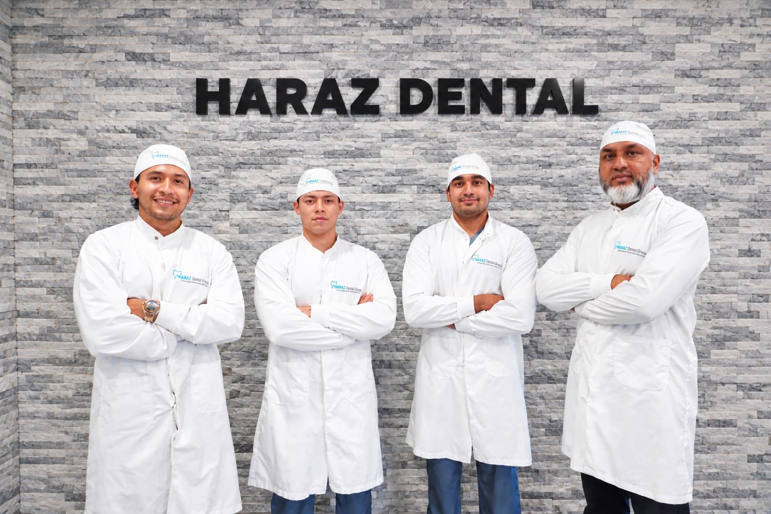The Haraz Dental Group team standing in front of the Haraz Dental sign